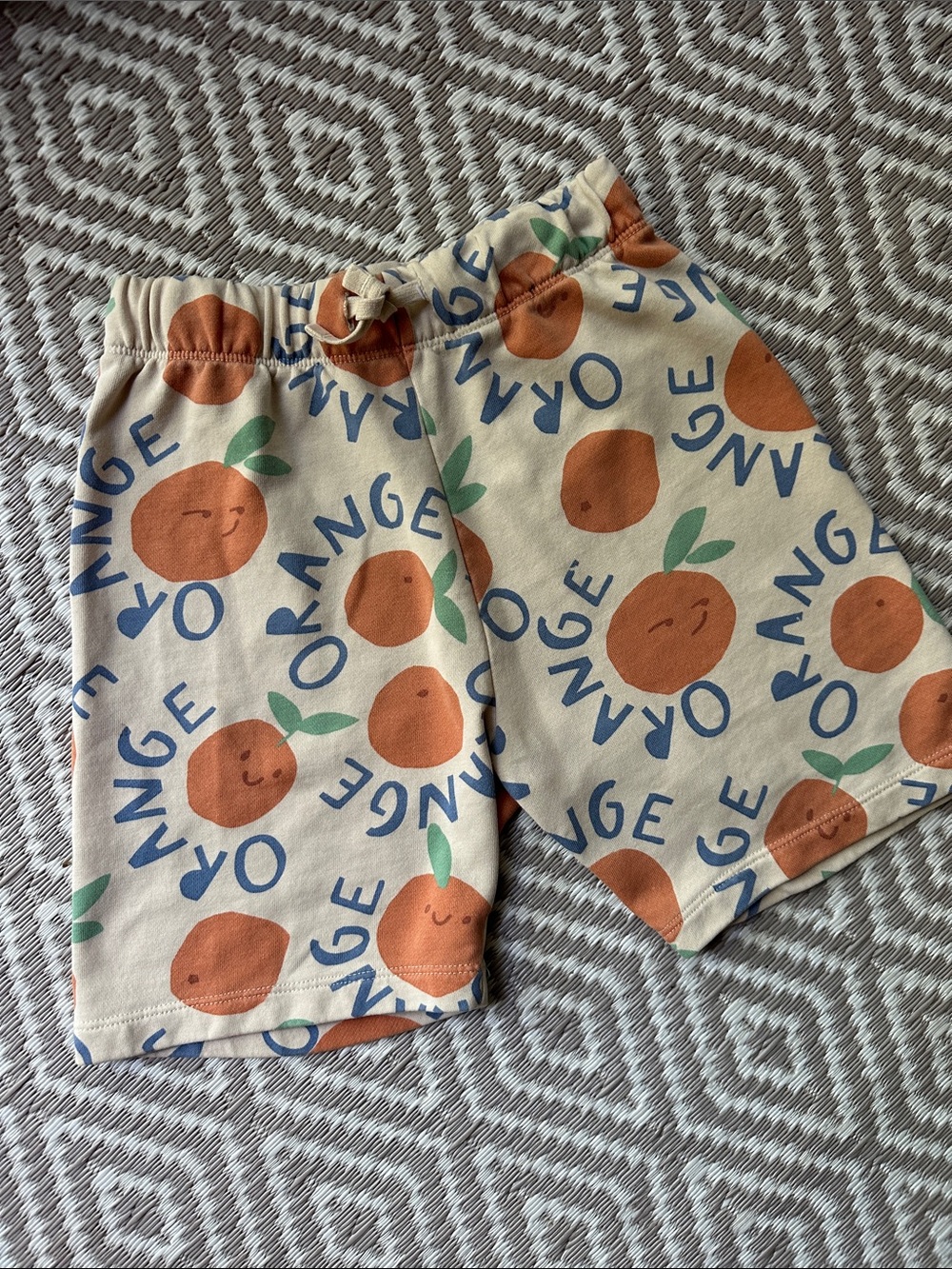 H&M Boys Cream Shorts with Orange Fruit Print and Blue Text